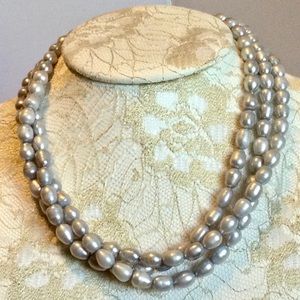 Light gray three strings faux pearls.